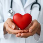 A healthcare professional holding a red heart object symbolizing care